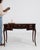 A refined Louis XV style desk featuring graceful curves, brass detailing, and functional casters for mobility. The design...