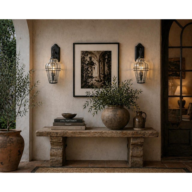 Architectural, sculptural, and highly decorative, this striking pair of vintage wall sconces features hand-blown Murano...