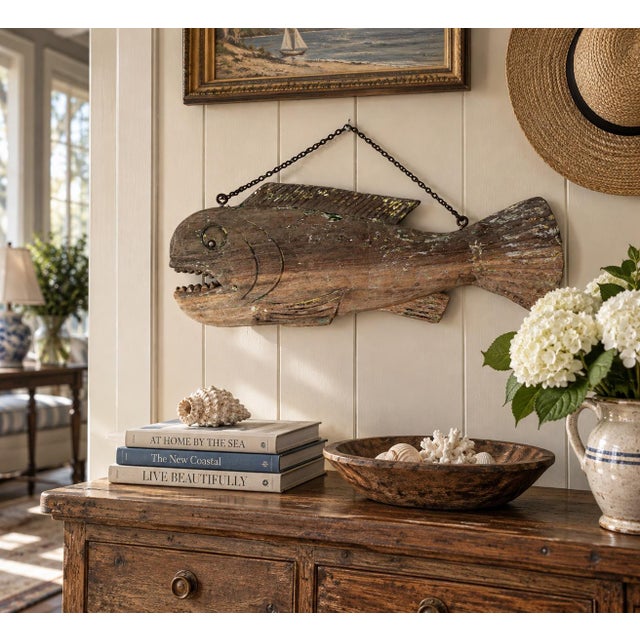 A wonderfully primitive early-to-mid-20th-century hand-carved wooden fish, believed to have originally hung at a seaside...