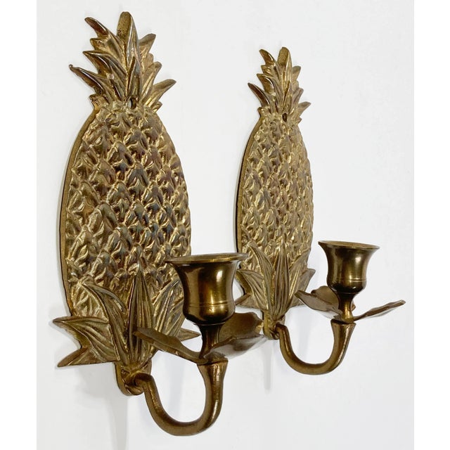Vintage detailed brass wall sconces with the welcome pineapple motif. Each holds a single taper candlestick. Holes for...