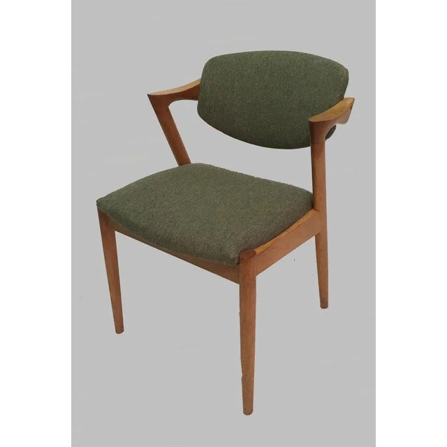 Kai Kristiansen Eight Restored Oak Dining Chairs, Including Custom Reupholstery. The chairs have Kai Kristiansens typical...