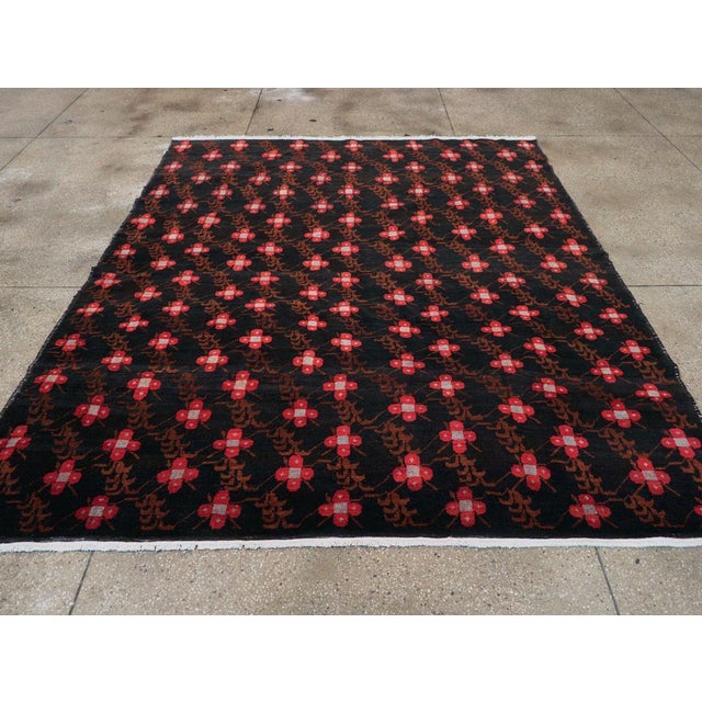 This mid-20th century Turkish Anatolian carpet, measuring 8' 1" x 9' 5", features a vivid allover design that masterfully...