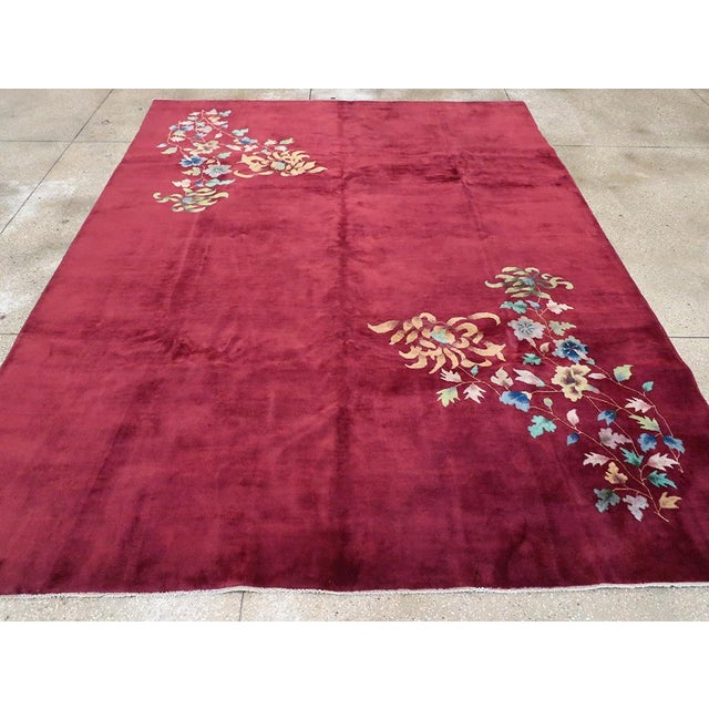 This elegant Mid-20th century Chinese Art Deco rug, embodies the refined aesthetic of the era with its rich, deep burgundy...