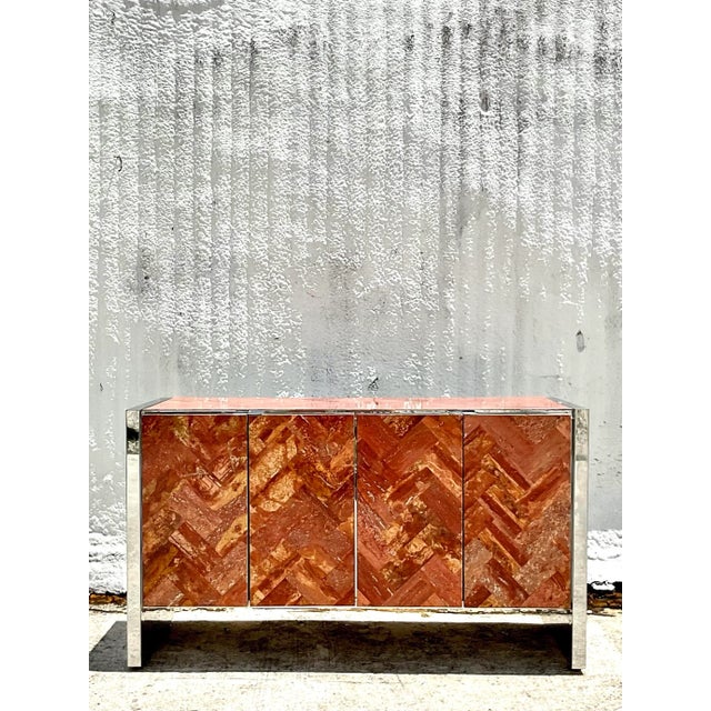 Incredible vintage 80s Ello credenza. Polished chrome cabinet with a chic Chevron stone front. A deep burnt orange color....