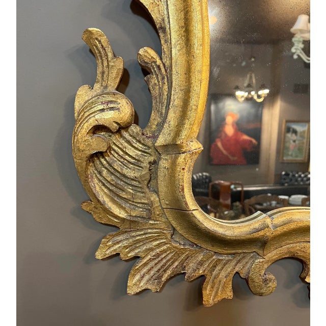 Antique 1800 Italian Gilt mirror. Extremely elaborate carving. Gilt over red background. Some repairs to support fragile...