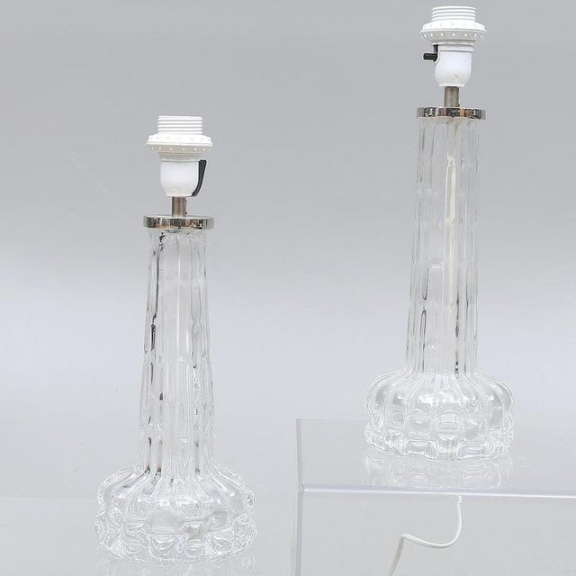 A stunning pair of mid-century modern crystal table lamps designed by Carl Fagerlund for Orrefors, Sweden, circa 1960s....