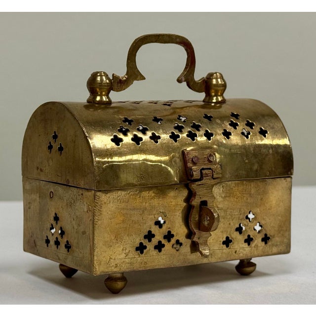Vintage pierced brass cricket box with domed lid and ball feet. Handle to top and brass clasp to hold treasures securely....