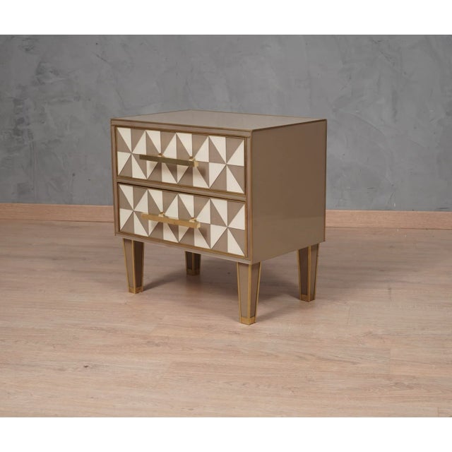 Classic design for a pair of night tables all in dove gray and white colored glass and brass. Square and linear as in the...