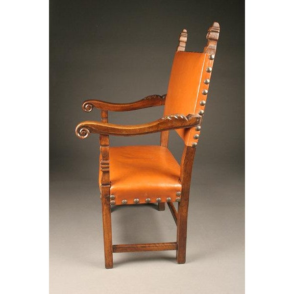 An elegant pair of 19th-century Italian armchairs in the Baronial style, dating to circa 1860. Crafted from carved walnut,...