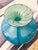 A beautiful glass vase in tones of green and blue designed by Michael Harris for Mdina, Malta. Measures: approx. 5.5" x 5"...