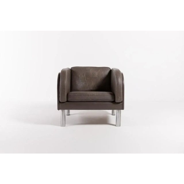 Jørgen Gammelgaard low-back armchair upholstered in gray leather, loose cushions with down filling, round legs in chromed...