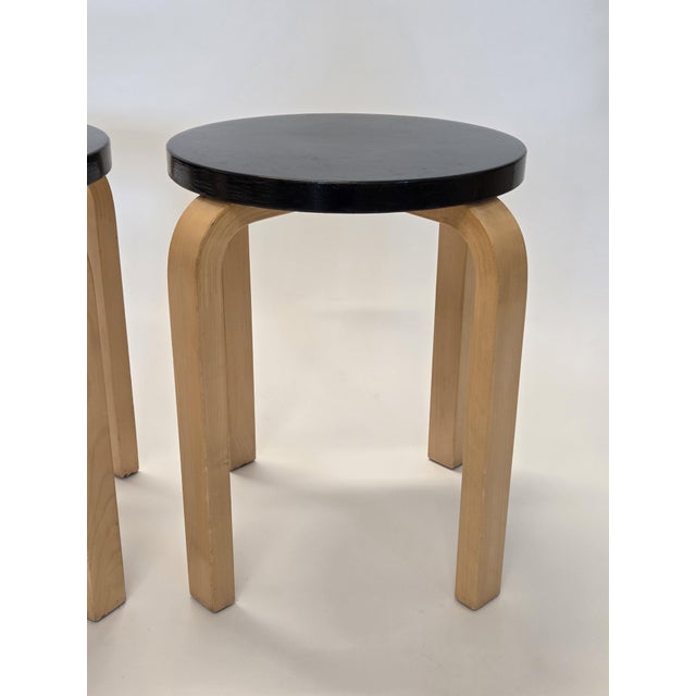 Artek E60 stools, 2 pcs. Birch with black painted top. The stools are from the 1960s and in good used condition. The...