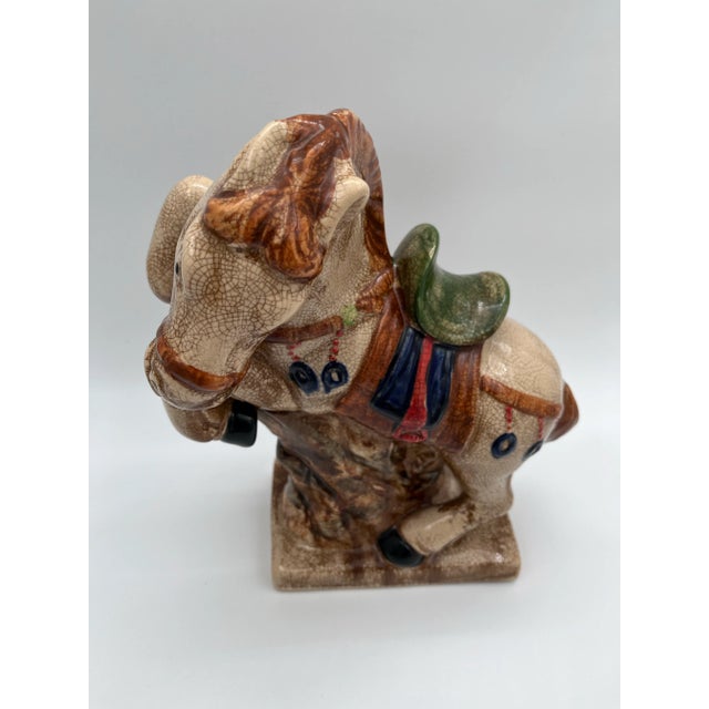 Late 20th Century Majolica-style Asian war horse statue. The statue is decorated with a colorful glaze and a crackle...