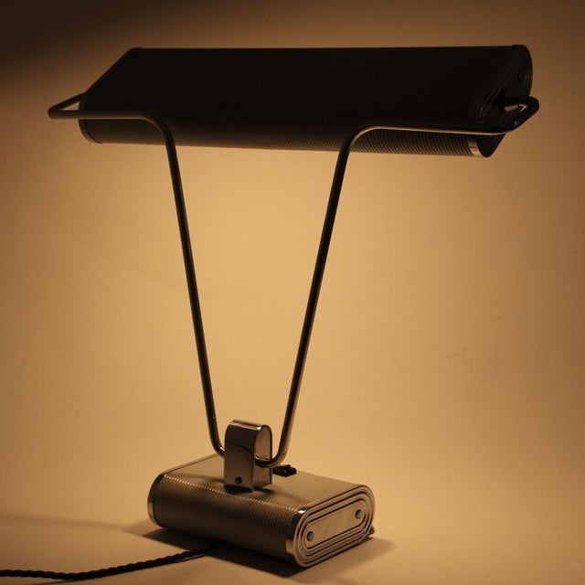 This lamp was designed by Eileen Gray for Jumo in France. It is made from corrugated steel, originally grey painted and...