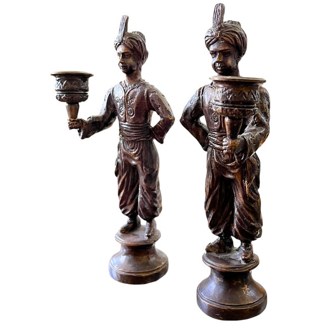 An unusual pair of vintage Maitland-Smith-style torchbearer candlesticks with enough sculptural presence to display...