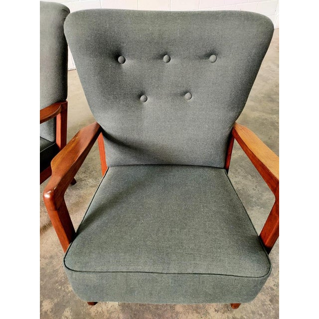 Armchairs made in Denmark in the 70s, with teak wood structure and gray fabric upholstery. Measurements: seat height 46cm,...