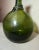 This rare antique flask is a very unique piece of Middle Eastern history. The hand blown green glass, lovely silhouette,...