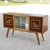 Two-tone mobile bar with carved deer that decorates the counters while the central part has two glass doors to scroll with...