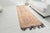 This is a vintage Turkish Oushak rug from the Mid 20th Century. The piece was hand-knotted.