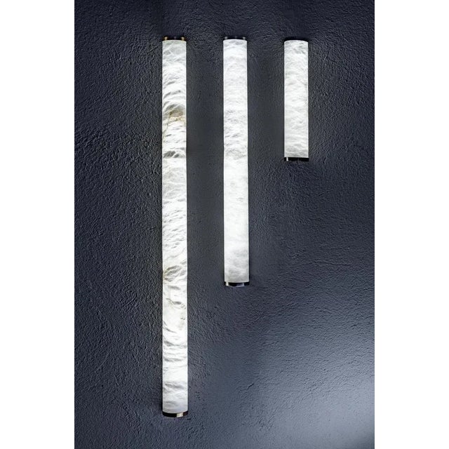 Slim ws 32 wall lamp by united alabaster dimensions: d 6 x h 32 cm materials: alabaster, copper (black nickel finish) also...