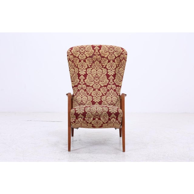Vintage armchair with a teak frame. The clean lines of the frame meet a comfortably high backrest, providing a comfortable...