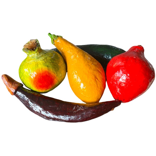 A joyful, sculptural set of five oversized papier-mâché vegetables, hand-formed and vividly painted in saturated, almost...