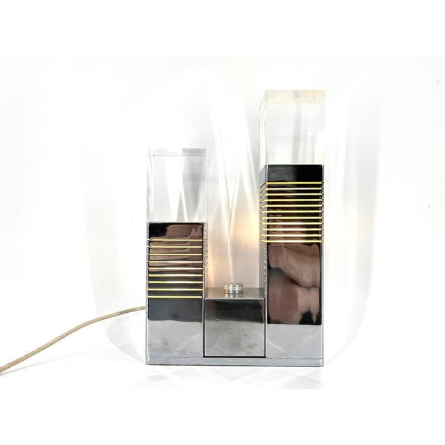 Rare Geometrical design table lamp attributed to Gaetano Missaglia. This timeless lamp is made from chrome and has two...