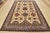 A tribal Caucasian Kazak rug hand-knotted with an all-wool pile on a cotton foundation. This oriental rug features...