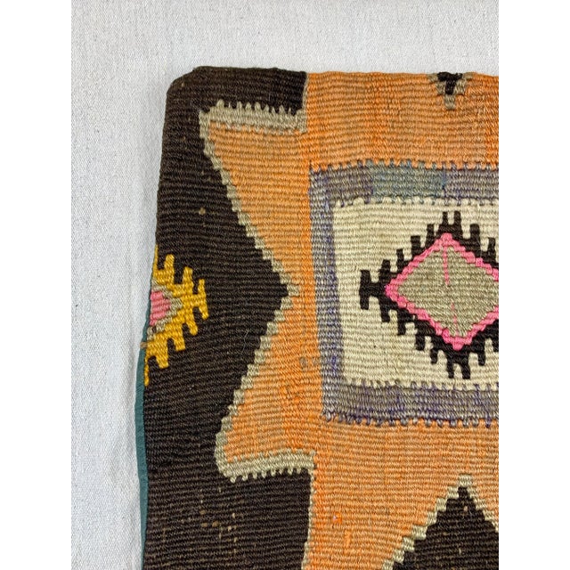 Beautiful vintage Turkish Kilim pillow cover. Features a geometric design with vibrant colors. Perfect to use on a sofa or...