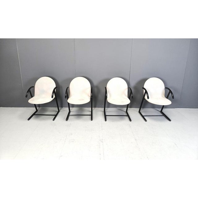Set of 4 postmodern design armchairs/dining chairs made from black metal frames and black grey fabric seats and backrests....