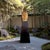 A monumental Thai-style Buddha head sculpture presented on a lacquered pedestal, executed as a contemporary architectural-...