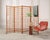 An impressive mid-century modern four-panel teak geometric latticed folding screen or room divider in light honey-toned...