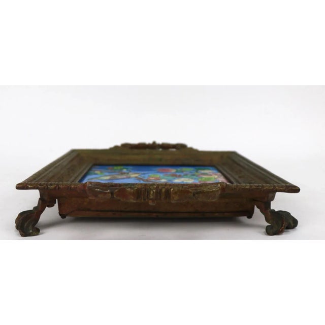 Longwy tile plaque in heavy cast brass footed frame, or trivet. Original condition, free of damage. Tile alone without...