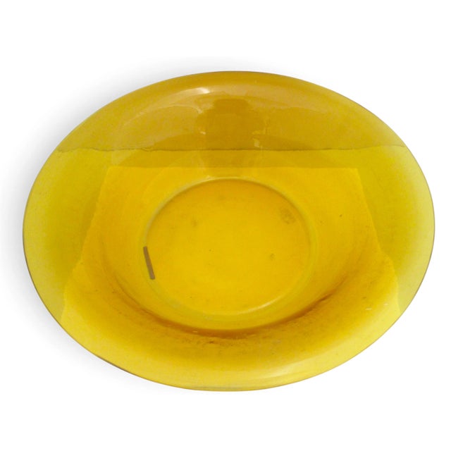 Large round Chinese Peking glass bowl in monochrome golden amber yellow glass. Heavy glass bowl with wide rim. Measures 12...