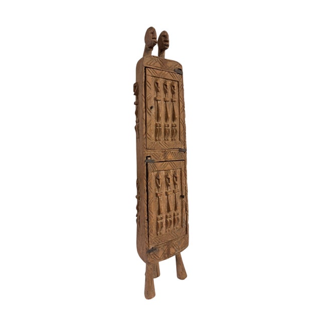 Superb and unique hand-carved wooden box from the Dogon tribe of Mali, featuring a double-door design traditionally used...