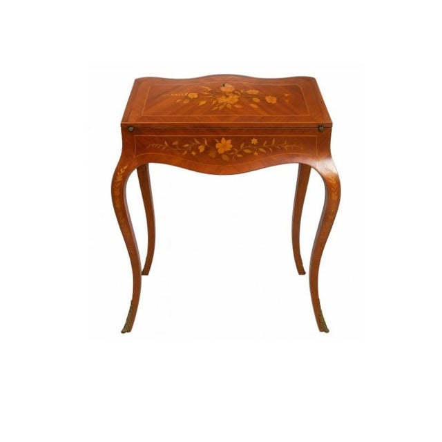 An elegant Louis XV style bureau de dame (lady's writing desk). The sloping hinged lid is inlaid with a floral marquetry...