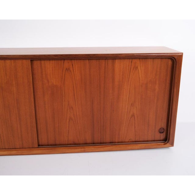Danish design sideboard crafted from teak, designed by edmund jørgensen in the 1960s. The sideboard features sliding doors...