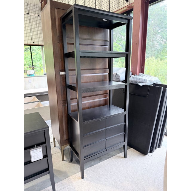 A refined Crate & Barrel Spotlight bookcase designed by Mark Daniel of Slate, distinguished by its tall architectural...