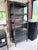 A refined Crate & Barrel Spotlight bookcase designed by Mark Daniel of Slate, distinguished by its tall architectural...