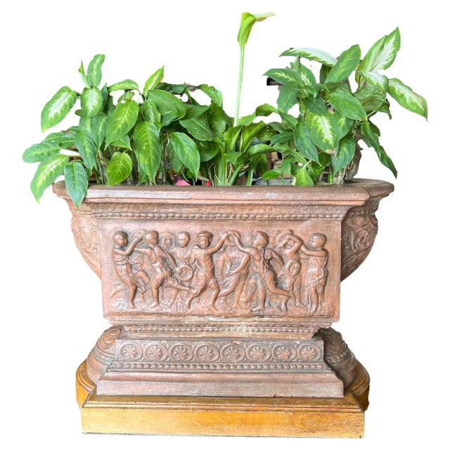 Terracotta planter centerpiece with dancing cherubs, Florence Circa 1820. Centerpiece total measures: 27”L x 14.25”W x...