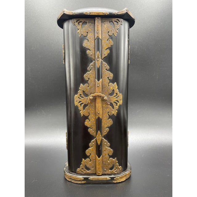 Lacquered and gilt travelling shrine with standing Kannon. Intricate etched bronze fittings on the door, base and corners....