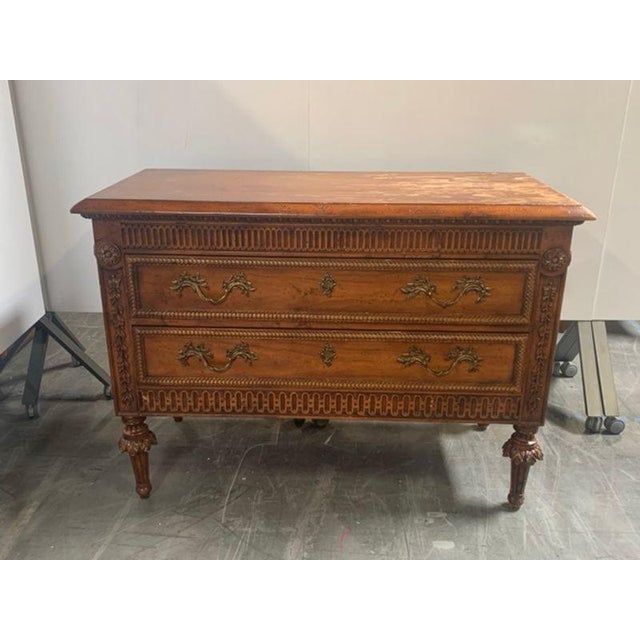 Carved Wood Chests Featuring Two Drawers With Decorative Brass Handles, Fluted Details, And Carved Floral Elements On Legs...