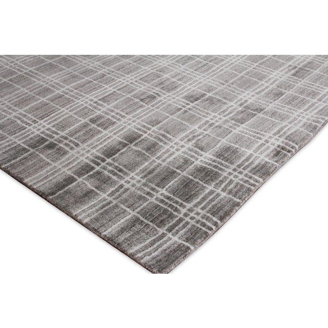 The Fairbanks rug catches your eye with its sharp and fresh plaid pattern motif, soft sheen and soothing colors....