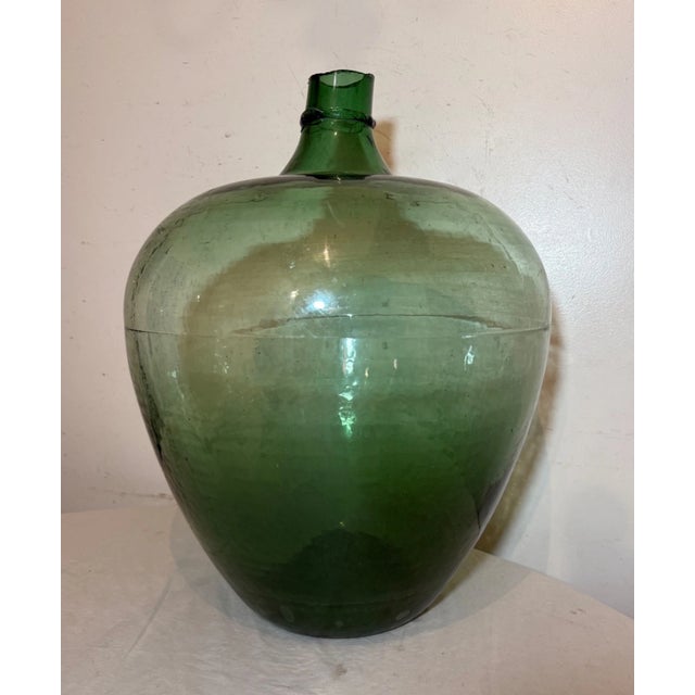 Up for sale is a rare and unique hand-blown green glass wine carboy bottle, hand made in the United States. This gigantic...