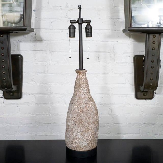 Glazed ceramic table lamp with bronze finish hardware.