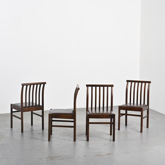 Set of four chairs by Japanese designer Isamu Kenmochi, circa 1970. Made of solid beech, these chairs feature a dark...
