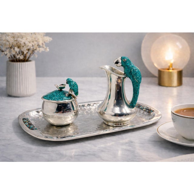 Striking mid-century creamer, covered sugar bowl, and matching spoon set, designed and manufactured in Taxco, Mexico...