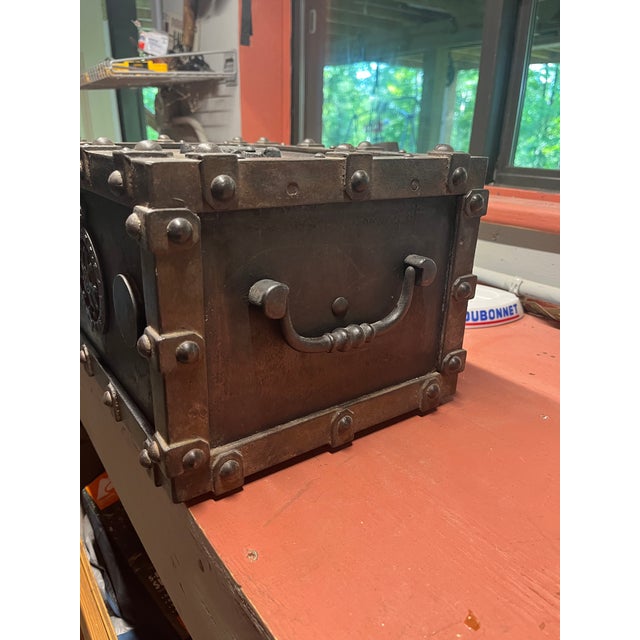 Cast Iron French Strong Box by Bauche with skeleton key. Raw polished iron finish with a detailed Royal Coat of Arms...