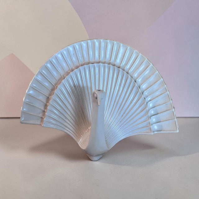 Bring a touch of whimsical modern glamour to your space with this retired Jonathan Adler ceramic peacock sculpture....