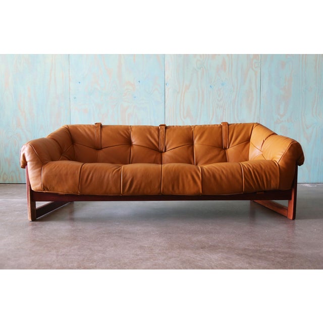 A solid jatoba and leather sling sofa by Percival Lafer for Brazil Industries circa 1970’s. This model MP-91 sofa is newly...